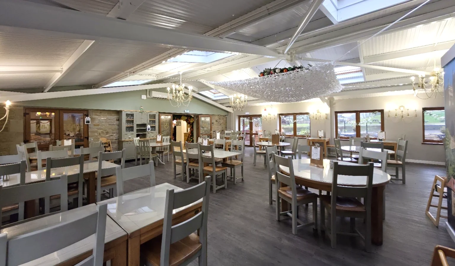 Homer Hill Café interior with tables, chairs, skylights and windows looking over the countryside